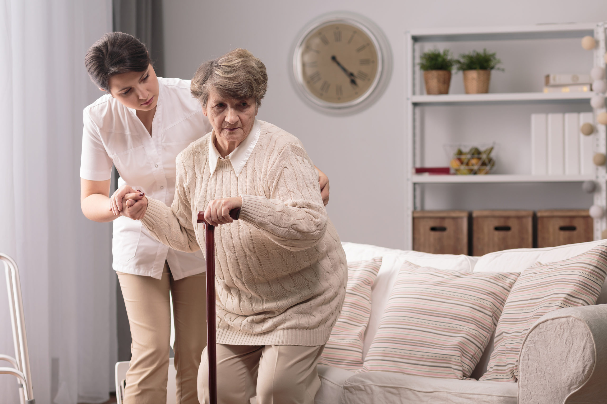 Helping To Stand Up Senior In-Home Care Western PA - caregiver helping elderly woman stand up