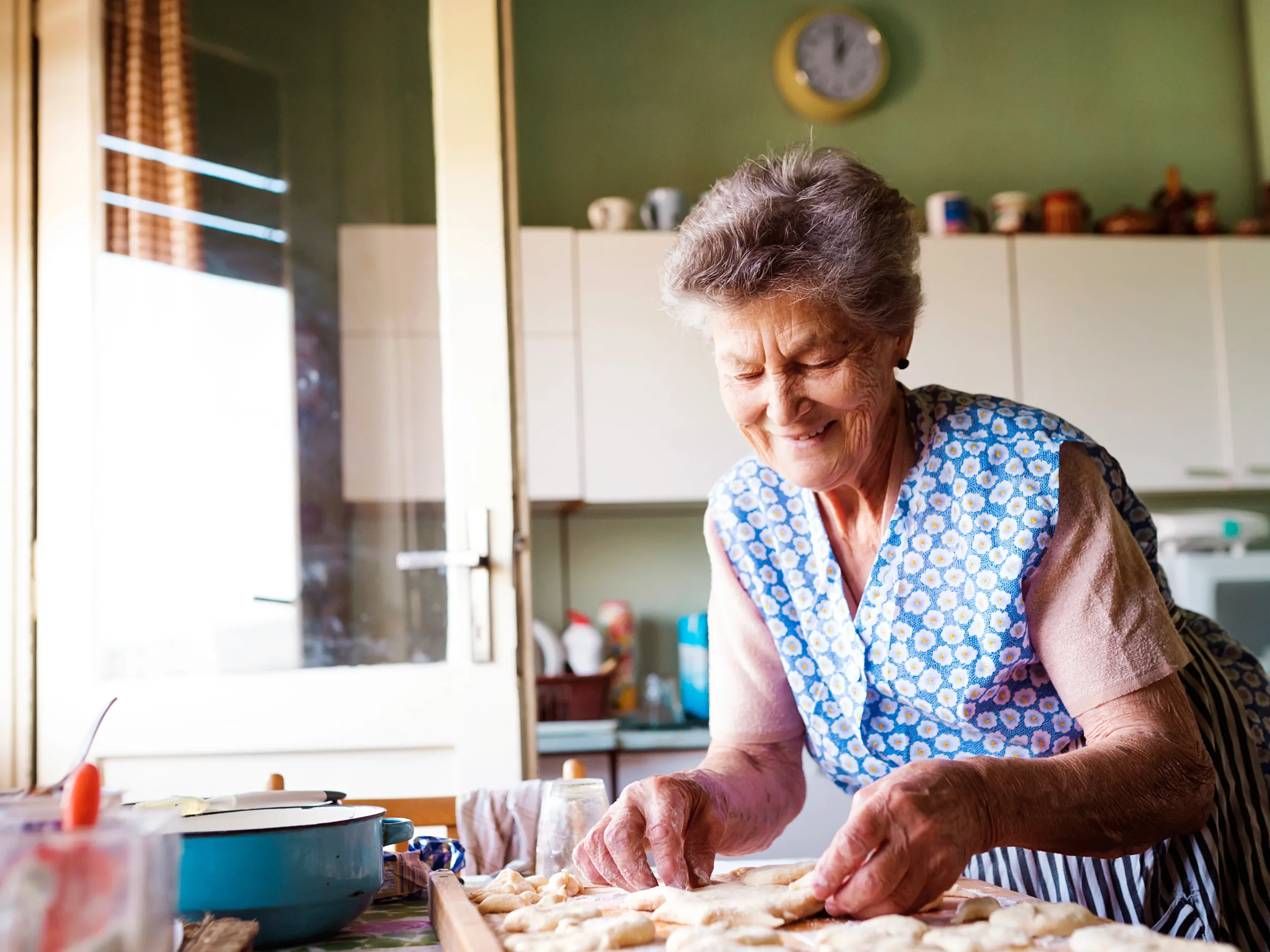 elderly woman baking in her kitchen