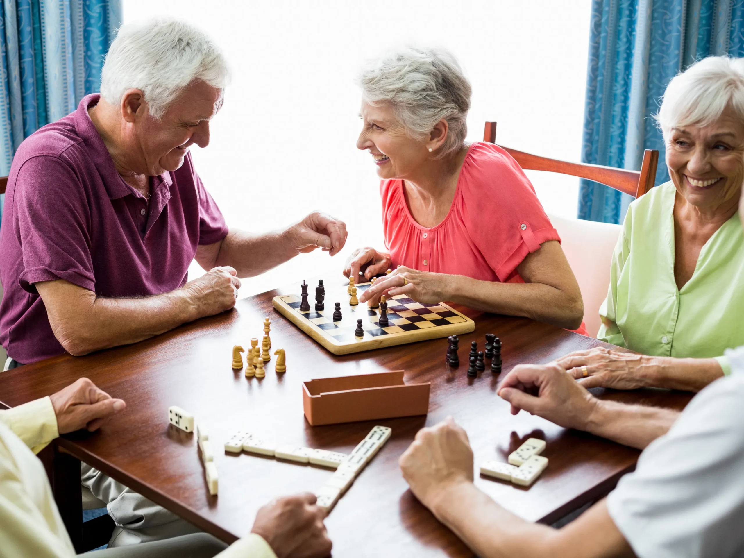 elderly group of friends enjoying board games together