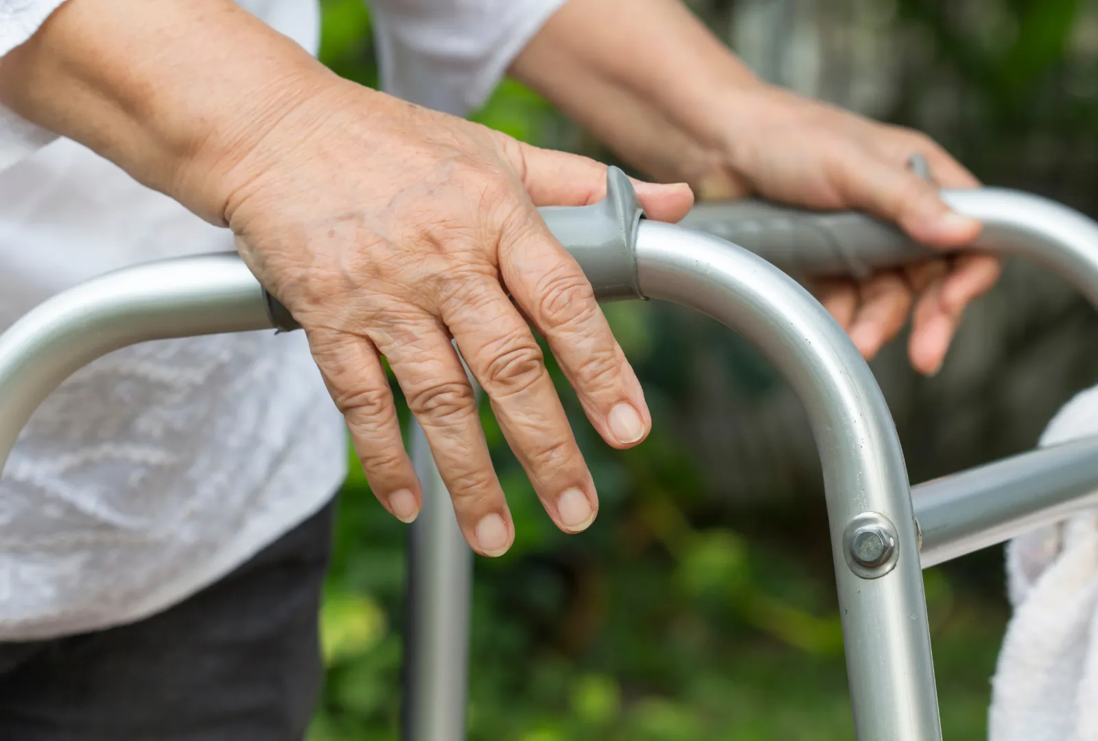 elderly hands pushing a walker
